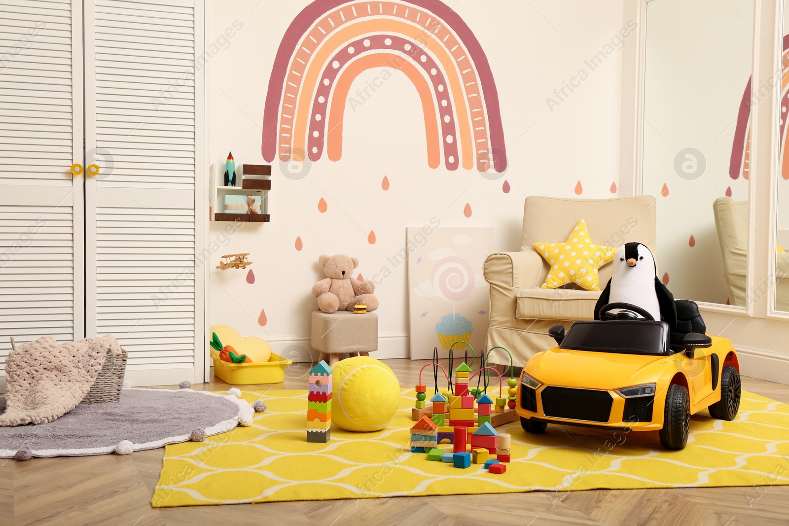 Photo of Child's electric car and other toys in playroom