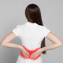 Woman suffering from rheumatism on light background