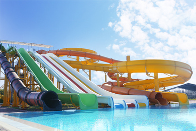 Photo of Different colorful slides in water park on sunny day