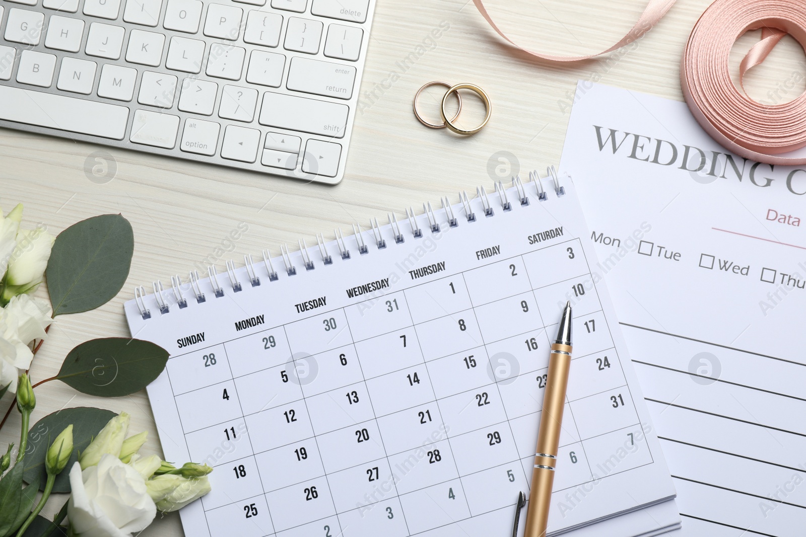 Photo of Flat lay composition with Wedding items and calendar on white wooden table