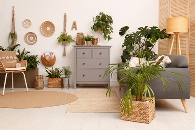 Living room interior with stylish furniture and green plants