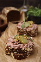 Photo of Delicious liverwurst sandwiches with pickled cucumber and mustard on table, closeup