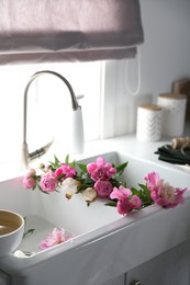 Photo of Bunch of beautiful peonies in kitchen sink