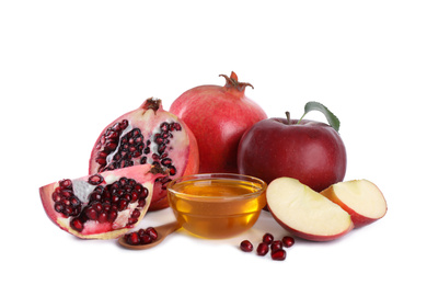 Photo of Honey, apples and pomegranates on white background. Jewish New Year (Rosh Hashanah) holiday