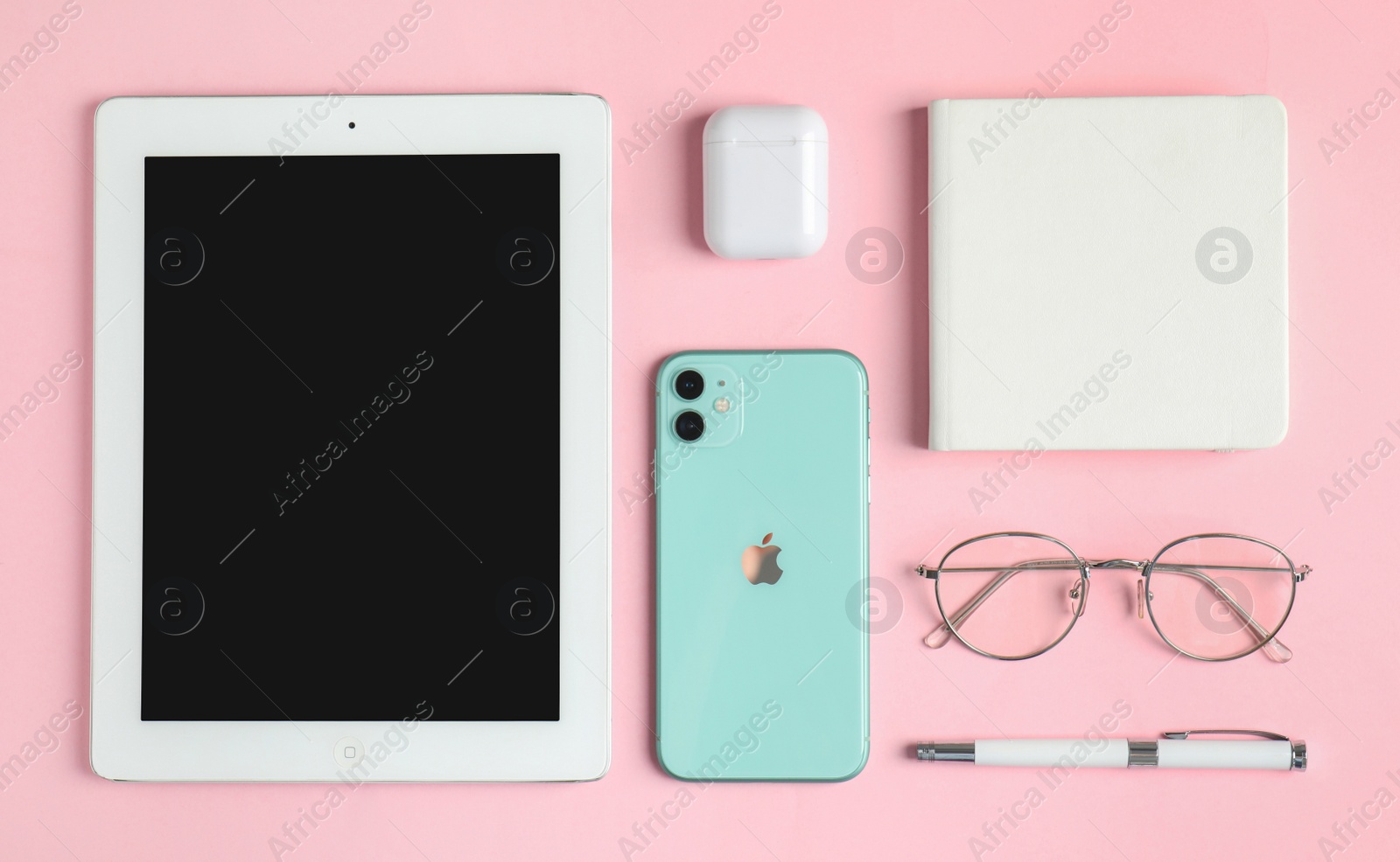 Photo of MYKOLAIV, UKRAINE - JULY 10, 2020: Flat lay composition with Iphone 11, IPad tablet and AirPods on pink background