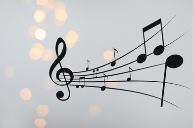 Image of Music notes on blurred background, bokeh effect