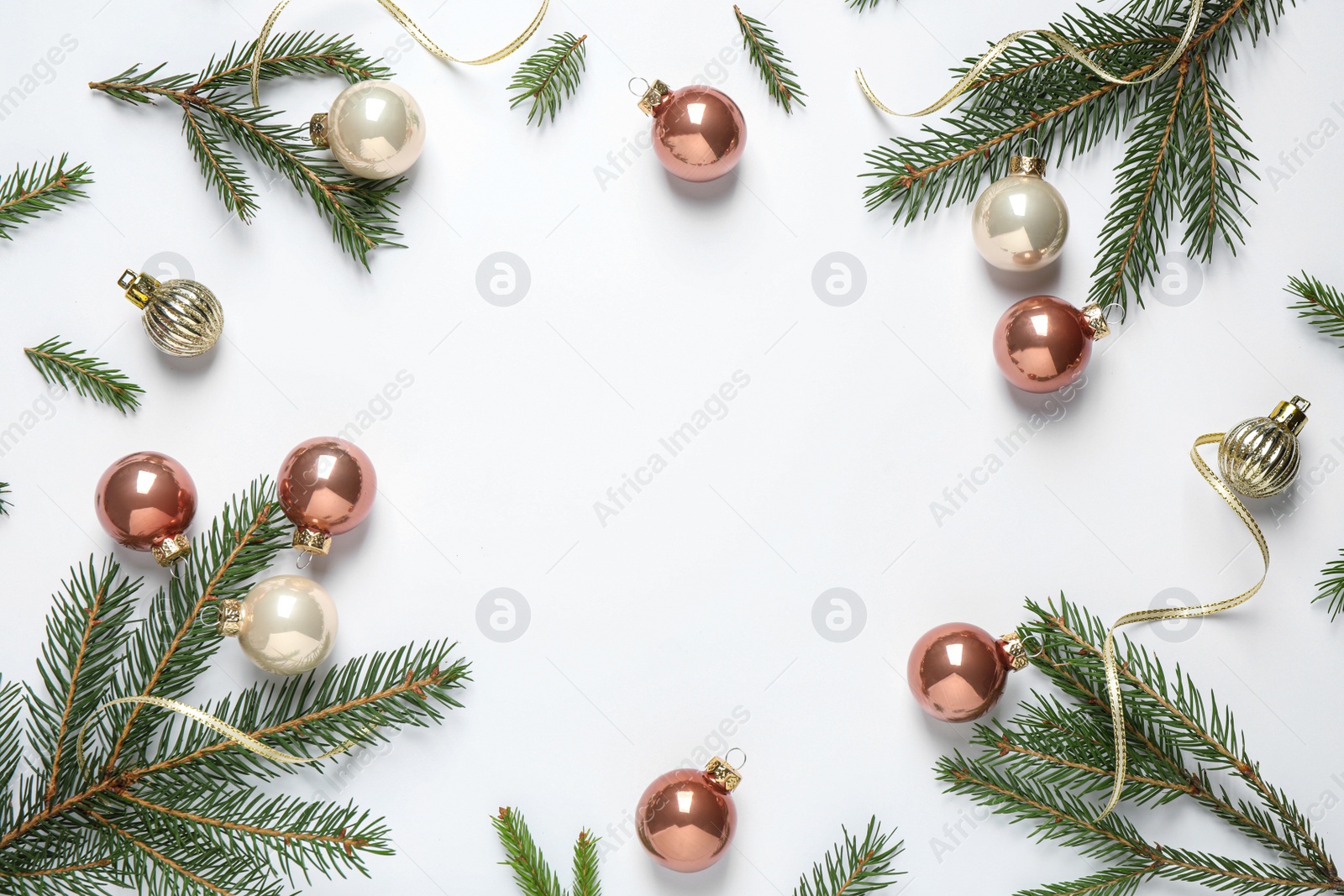 Photo of Frame of Christmas tree branches and festive decoration on white background, top view. Space for text