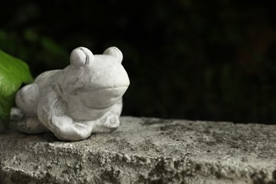 Photo of Beautiful frog figure on stone parapet, space for text