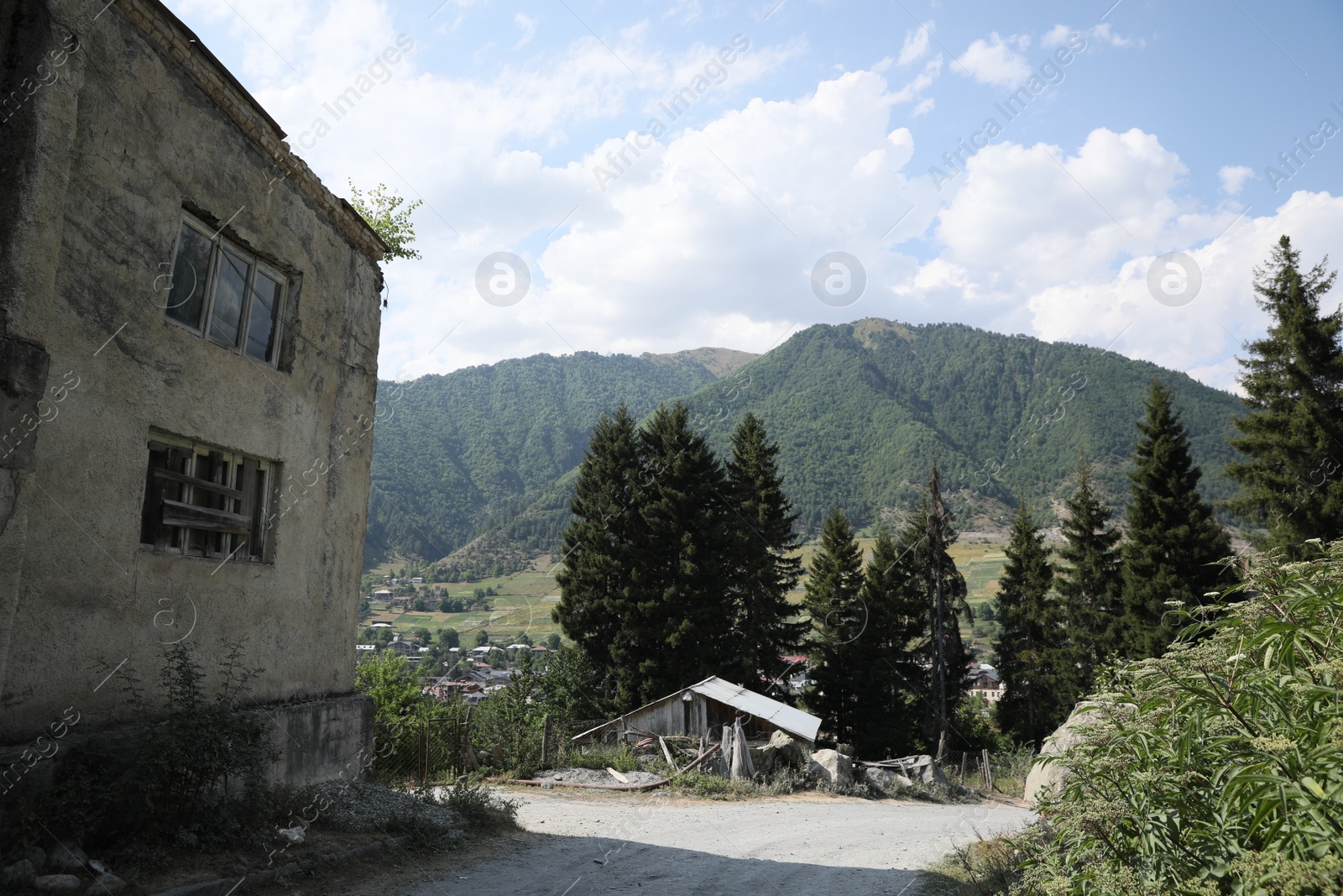 Photo of Picturesque view of beautiful mountains, trees and old building