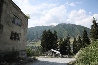 Picturesque view of beautiful mountains, trees and old building