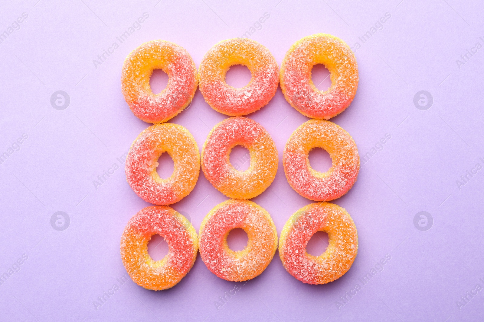 Photo of Tasty jelly candies on color background, flat lay