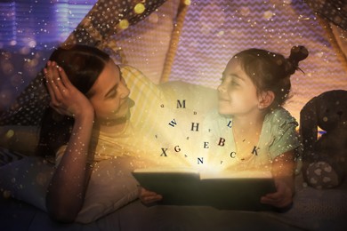 Image of Shiny magic book with letters flying over it. Girl with her mother reading fairy tale in play tent at home