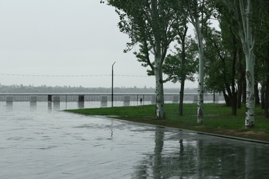 Photo of Empty city embankment under heavy rain on spring day