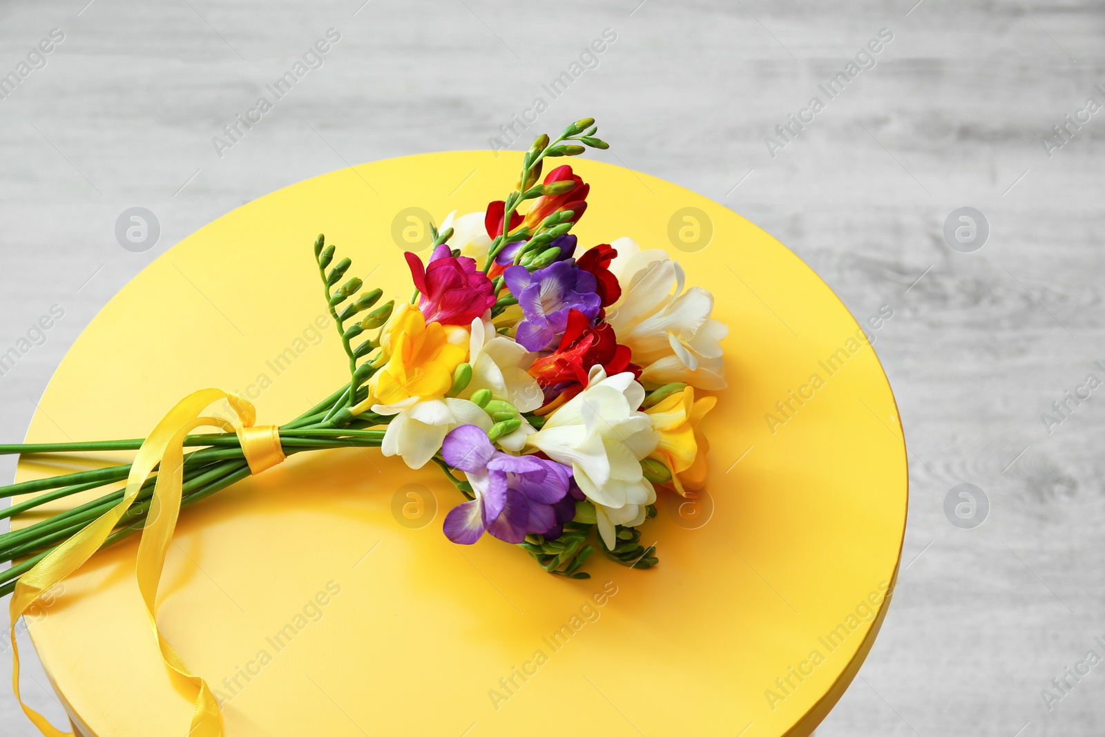 Photo of Beautiful freesia bouquet on table