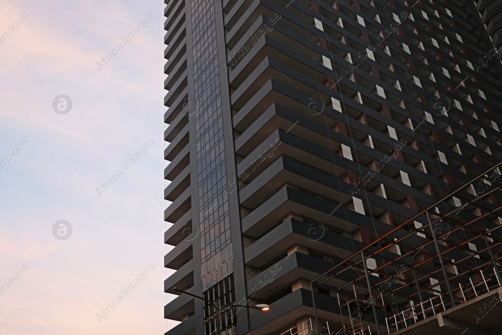 Photo of Beautiful skyscraper against blue sky, low angle view