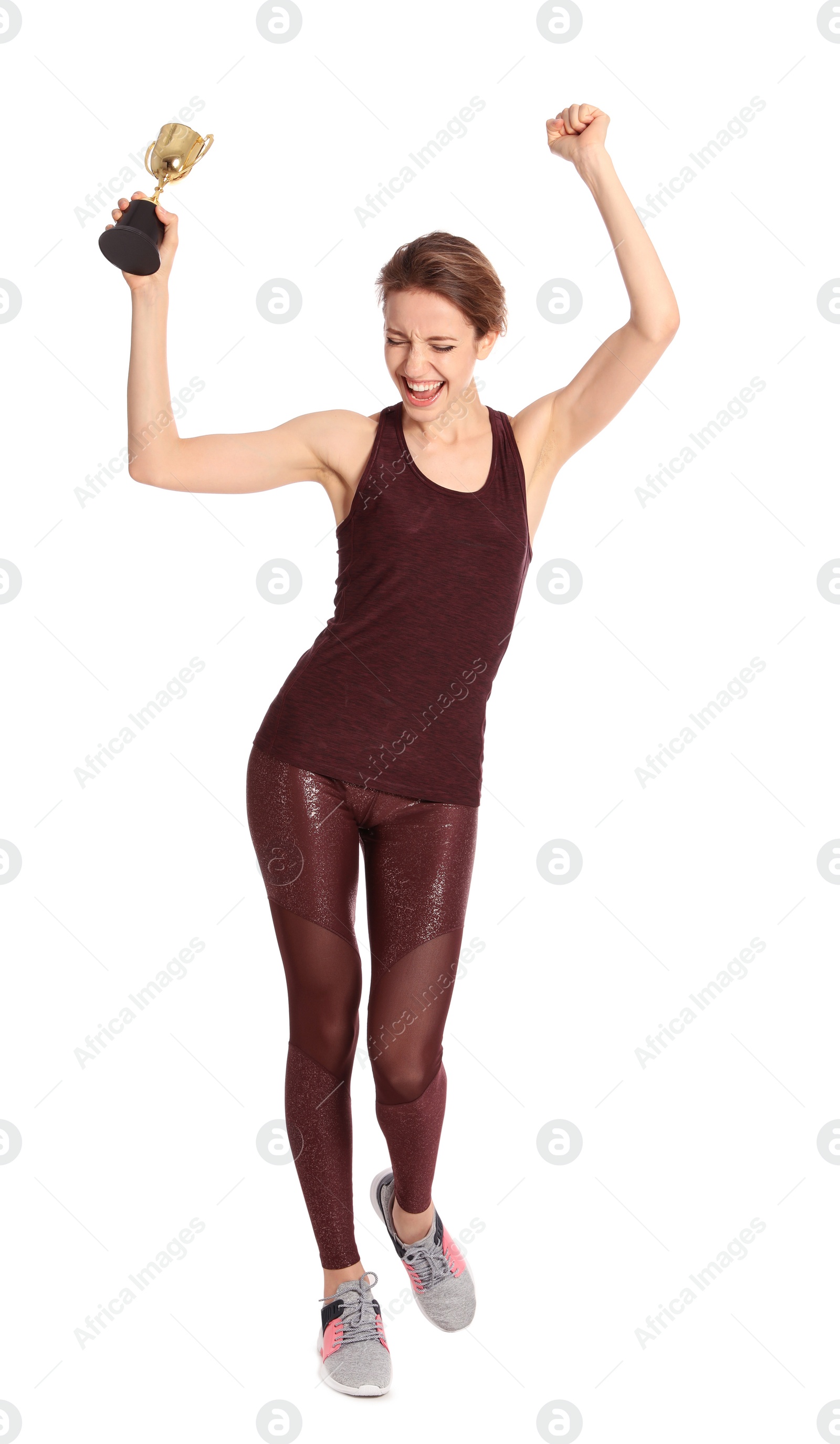 Photo of Full length portrait of happy young sportswoman with gold trophy cup on white background