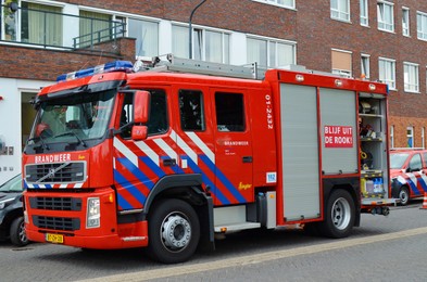 Photo of Oude Pekela, Netherlands - June 14, 2022: Modern red fire truck on city street