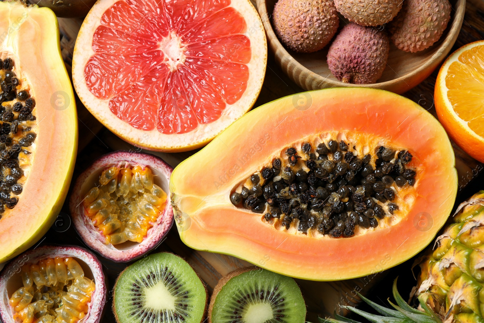 Photo of Fresh ripe papaya and other fruits on table, top view