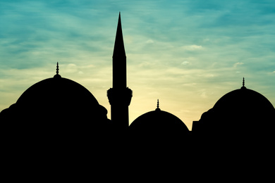 Image of Silhouette of mosque during sunset. Muslim culture