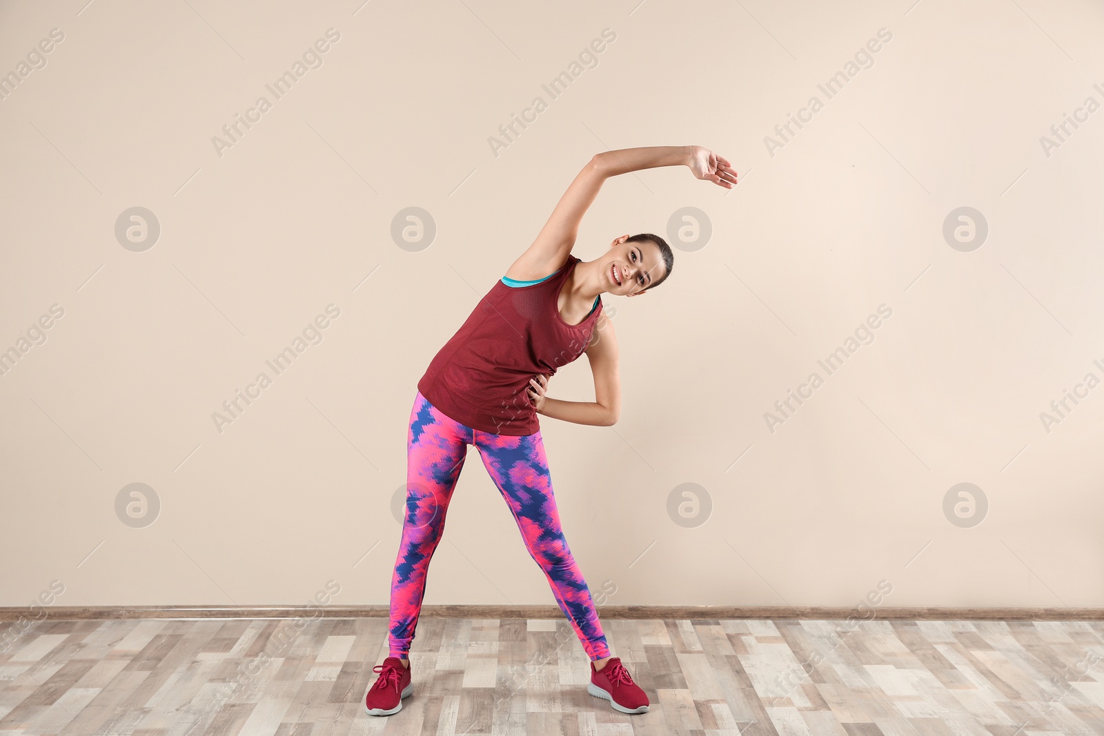 Photo of Young beautiful woman doing exercise at home. Workout and fitness