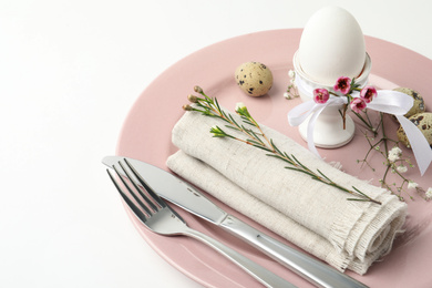 Photo of Festive Easter table setting with beautiful floral decor, closeup
