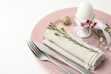 Festive Easter table setting with beautiful floral decor, closeup