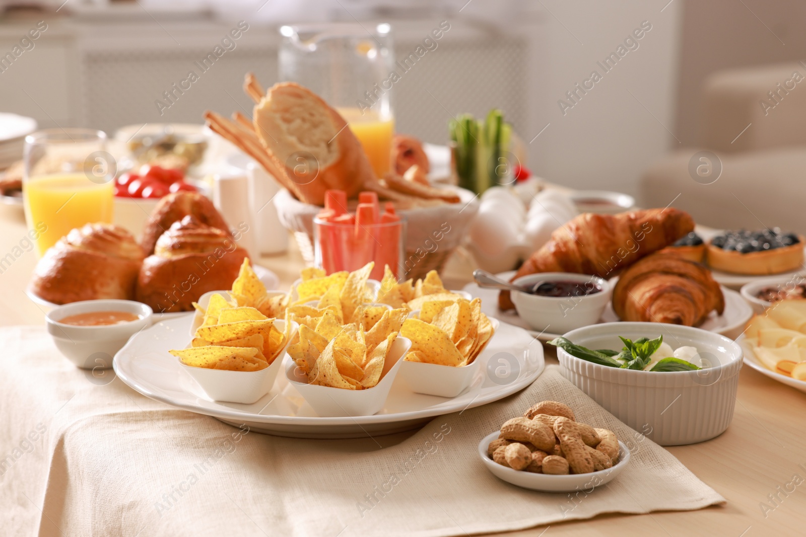 Photo of Dishes with different food on table in room. Luxury brunch