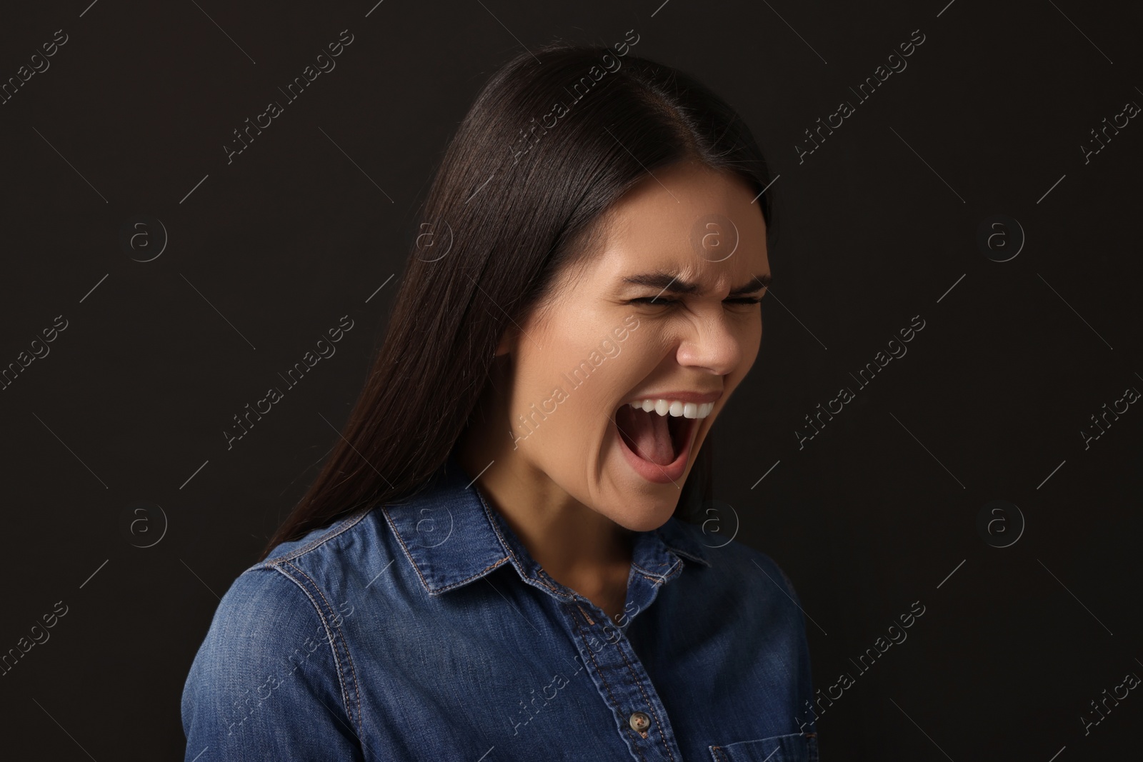 Photo of Personality concept. Emotional woman on black background