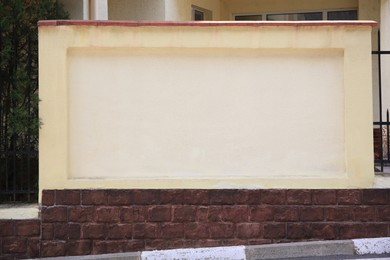 Photo of Beautiful white wall near house on city street