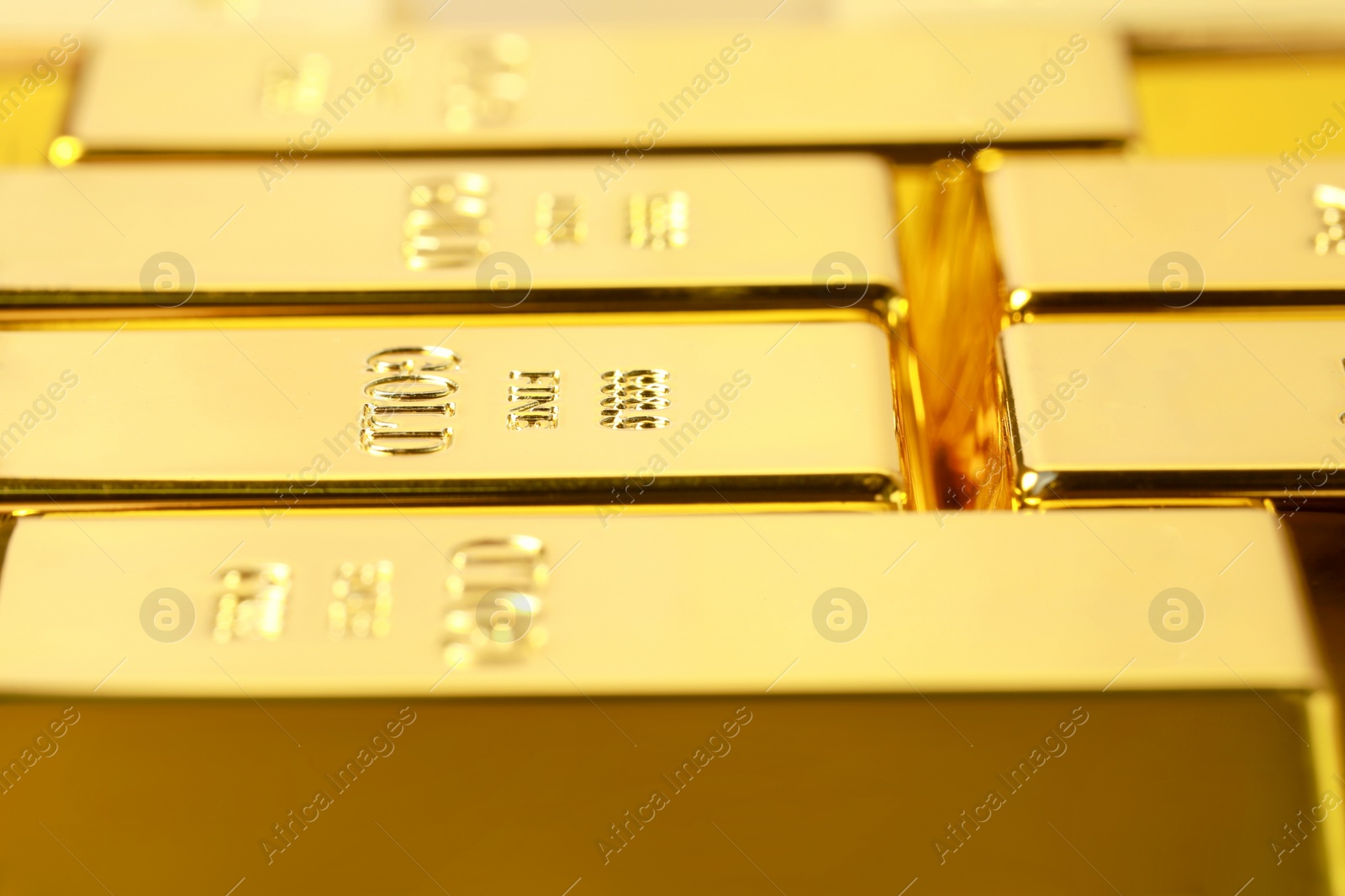 Photo of Many shiny gold bars as background, closeup