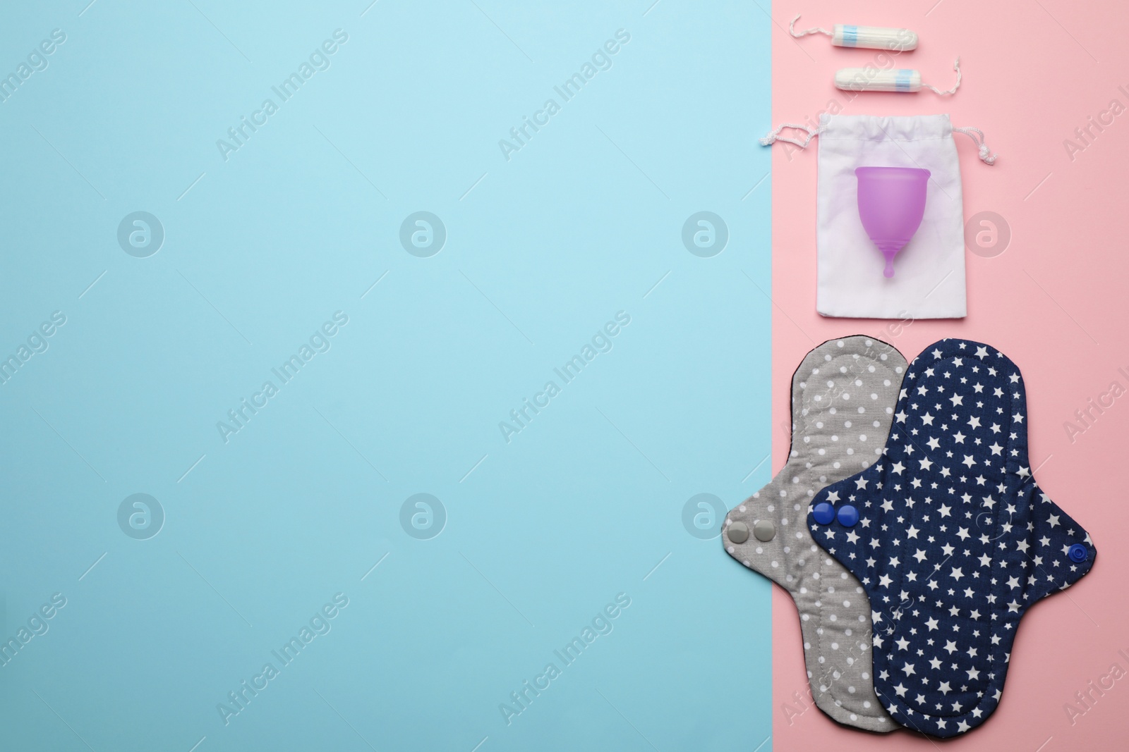 Photo of Reusable cloth pads, menstrual cup and disposable tampons on color background, flat lay. Space for text