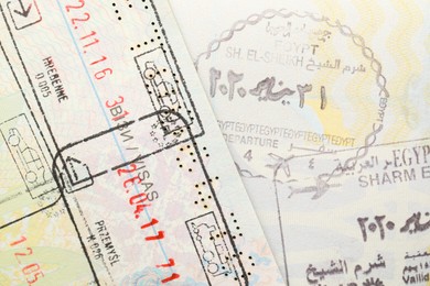 MYKOLAIV, UKRAINE - FEBRUARY 23, 2022: Passport pages with different visa stamps, closeup