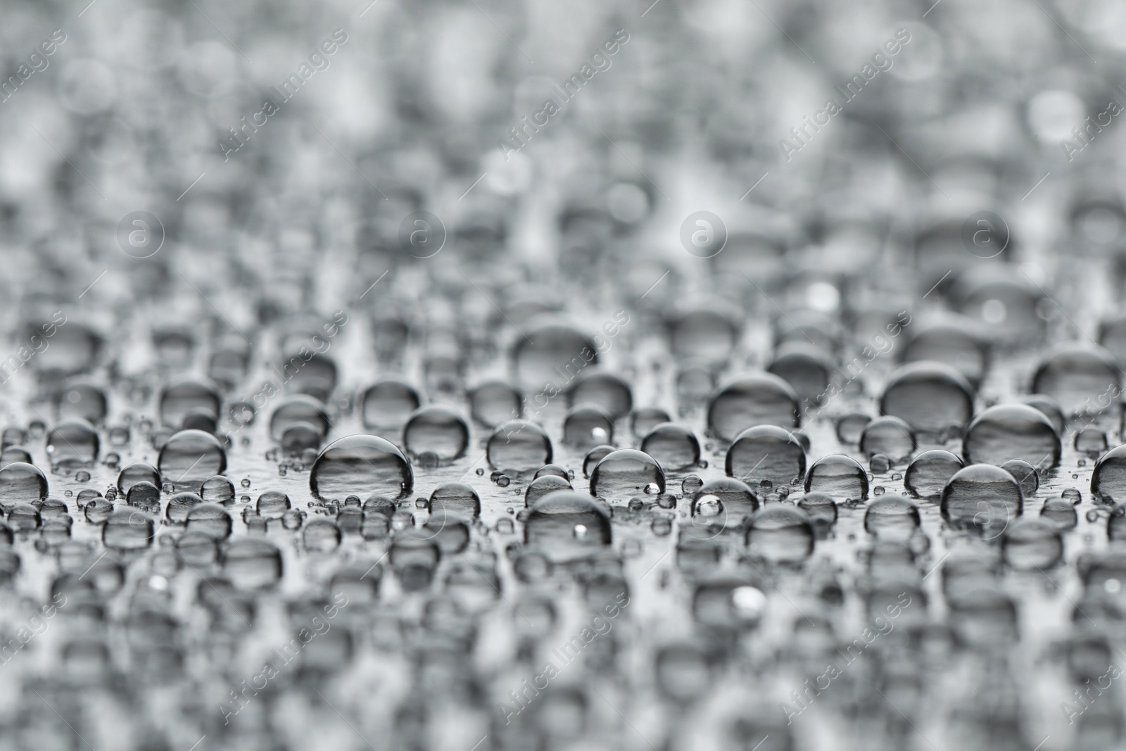 Photo of Water drops on grey background, closeup view