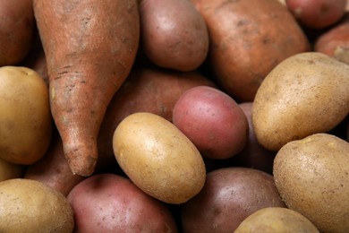 Different types of fresh potatoes as background, closeup view