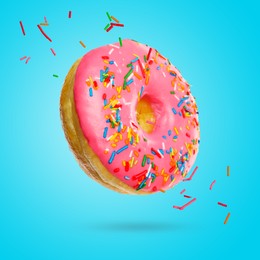 Image of Delicious donut falling on light blue background