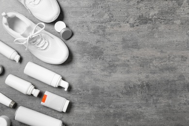 Photo of Flat lay composition with stylish footwear and shoe care accessories on grey background, space for text