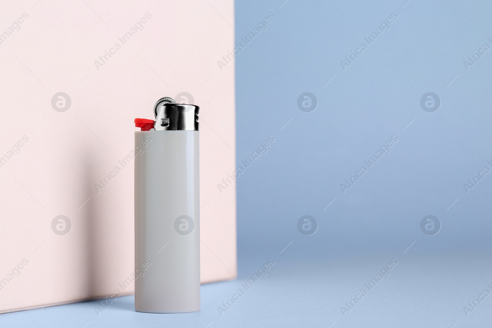 Photo of Stylish small pocket lighter on color background, space for text