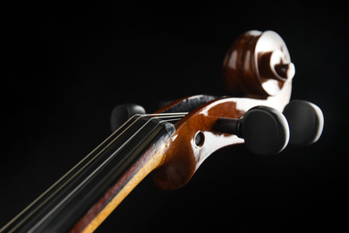 Photo of Beautiful violin on black background, closeup view