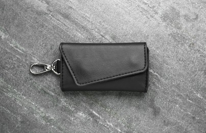 Photo of Stylish leather keys holder on grey table, top view