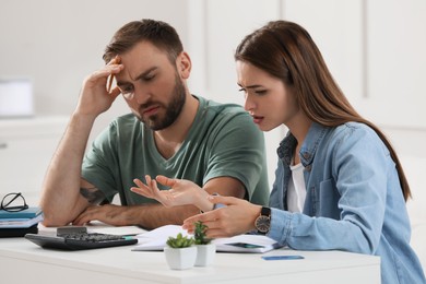 Young couple discussing family budget at home