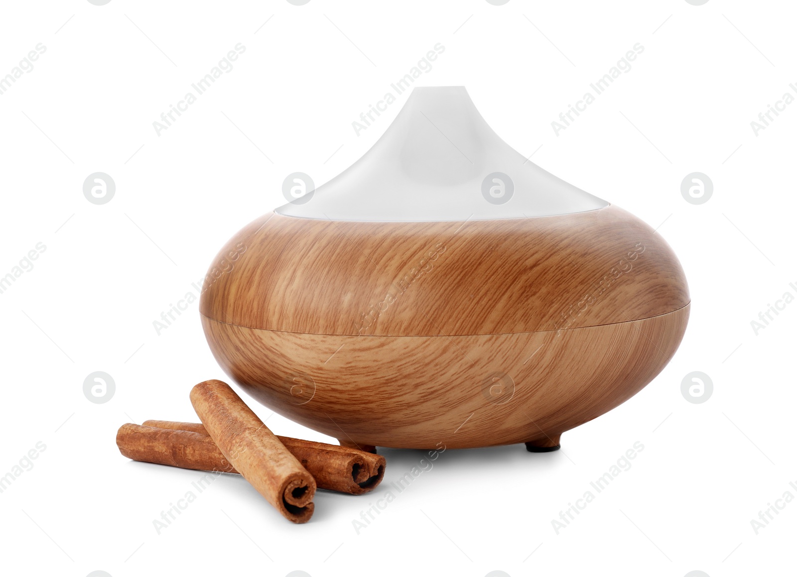 Photo of Aroma oil diffuser and cinnamon sticks on white background