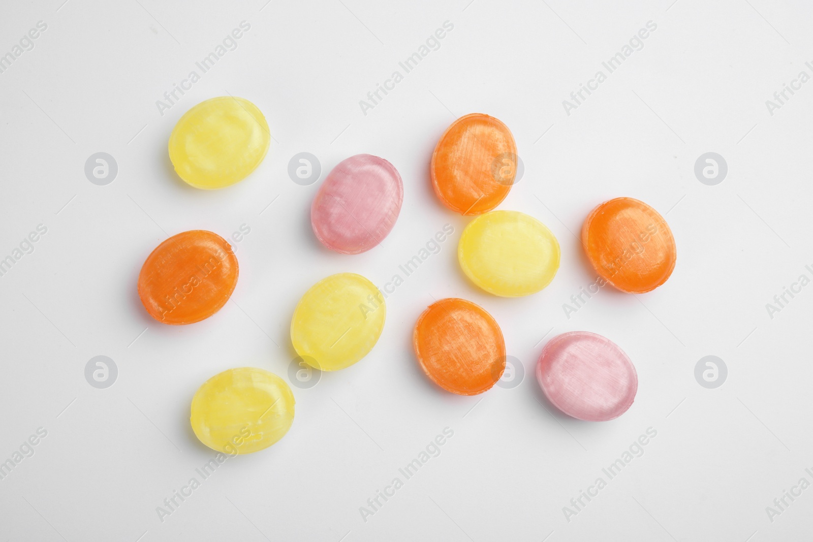 Photo of Delicious colorful candies on white background, top view