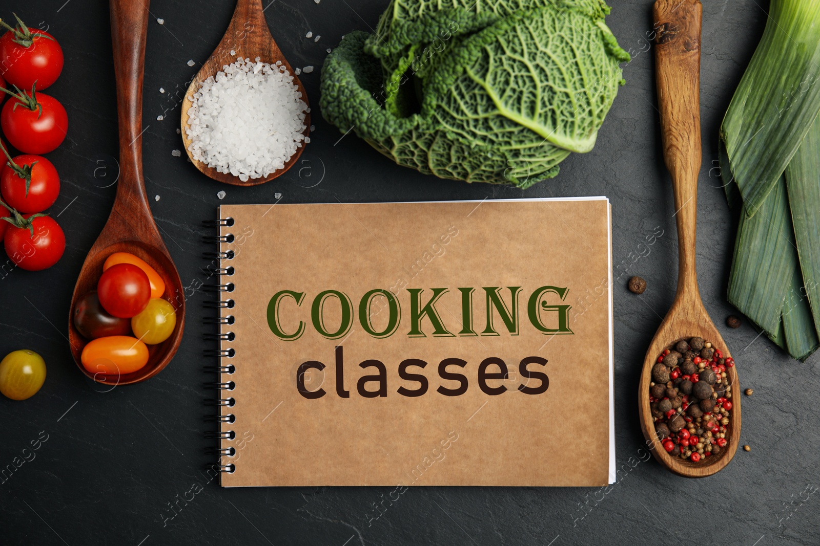 Image of Notebook with inscription Cooking Classes and different ingredients on black table, flat lay