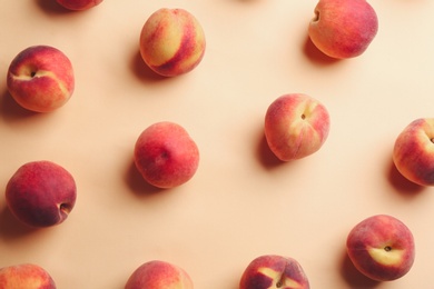 Photo of Fresh ripe peaches on beige background, flat lay