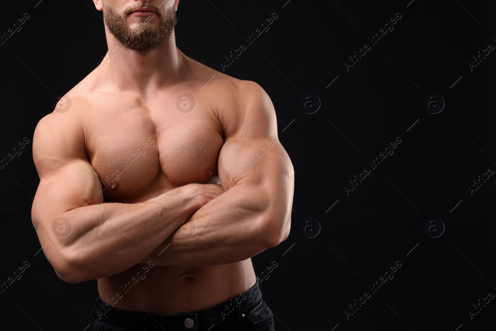 Photo of Muscular man on black background, closeup and space for text. Sexy body