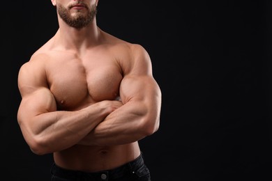 Photo of Muscular man on black background, closeup and space for text. Sexy body