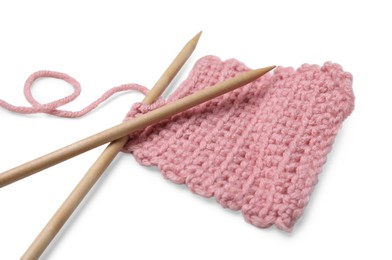 Photo of Pink knitting and wooden needles on white background, closeup