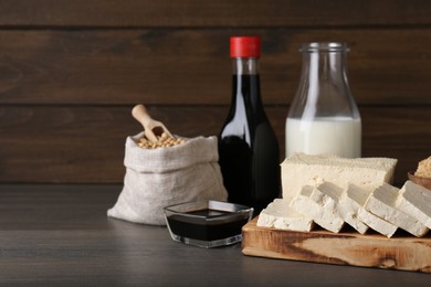 Photo of Different natural soy products on wooden table, space for text