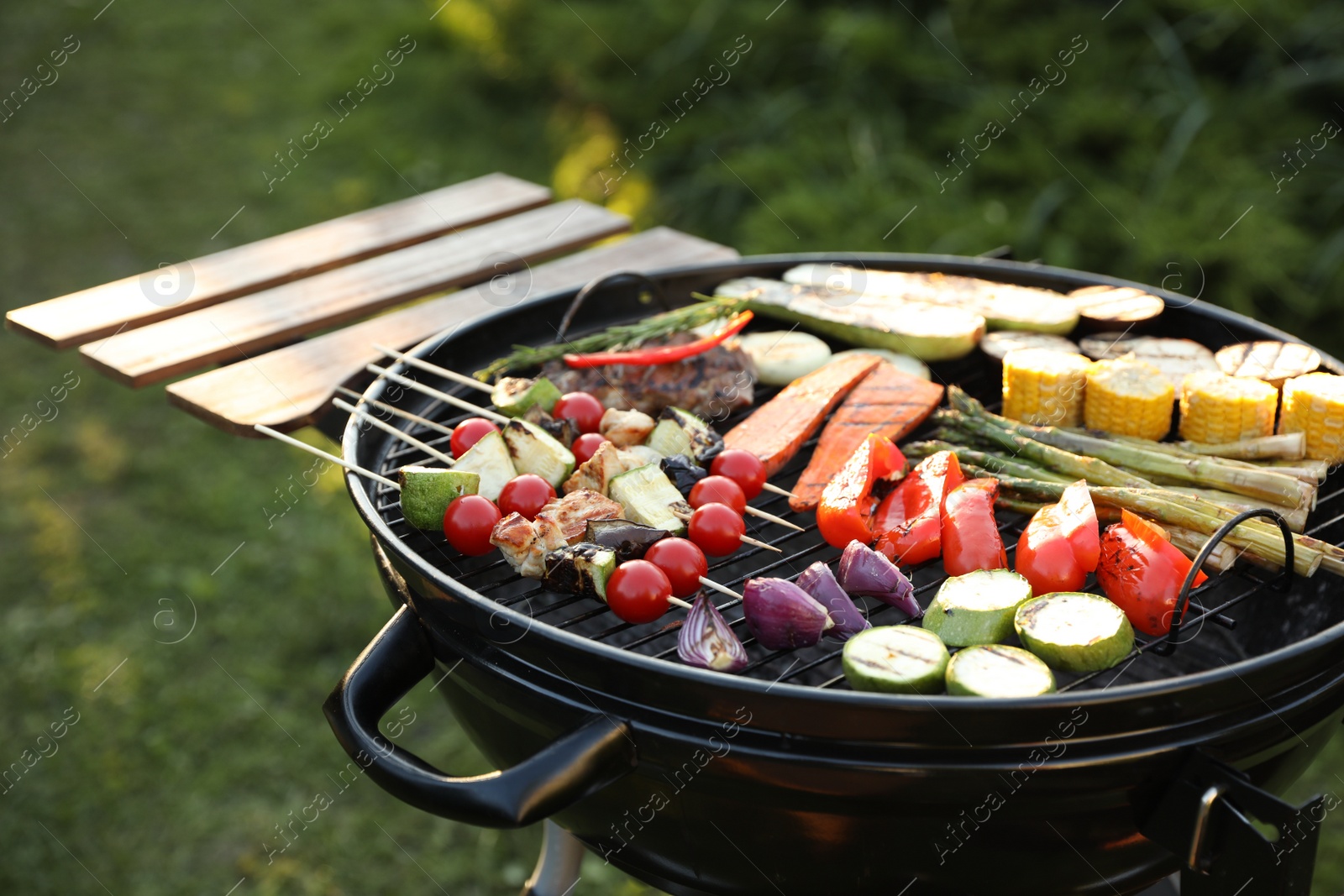 Photo of Delicious grilled vegetables on barbecue grill outdoors, closeup