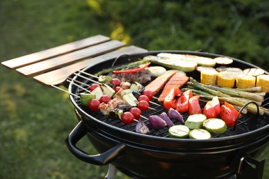 Delicious grilled vegetables on barbecue grill outdoors, closeup